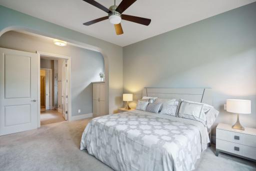 Primary bedroom with high ceilings and ceiling fan/light
