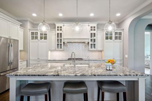Custom white cabinets have stylish glass windows