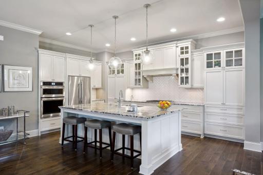 Kitchen features a center island with glass globe pendant lighting