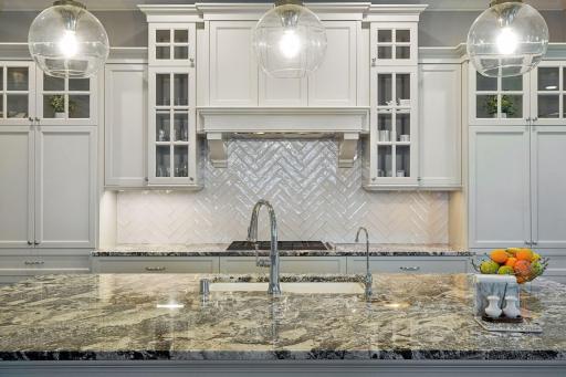 Beautiful herringbone tile back splash adds a touch of class to the room