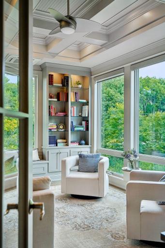 Enjoy a good book with your favorite beverage in this added library/den
