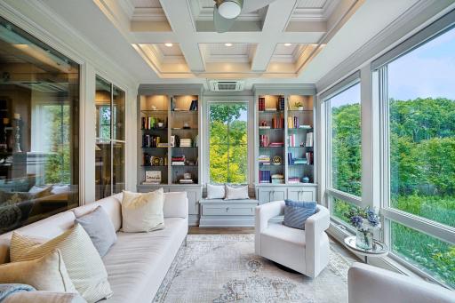 Coffered ceilings with inset lighting and gorgeous built-in shelving