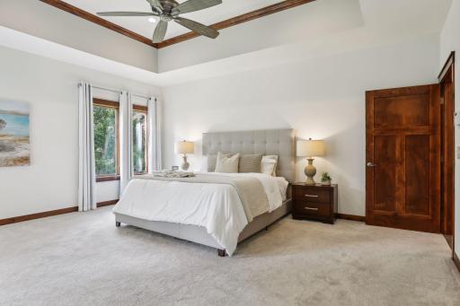 The primary suite is complete with 11' box vaulted ceiling, sitting area, and private spa-like bathroom.