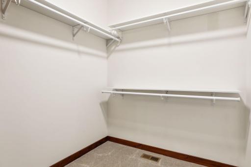 One of the two primary suite walk-in closets.