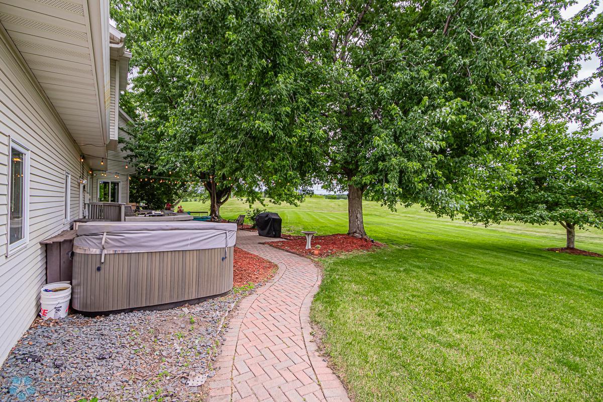Paver walkway wraps around to the front of the home