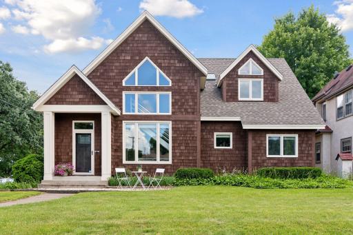 The front exterior offers great curb appeal—a paver patio in front with lush landscape surround.