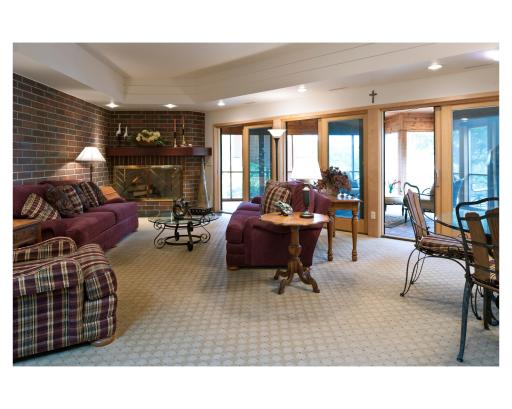Lower level family room at the Mary Hill Lodge, complete with fireplace and screened-in wrap-around porch