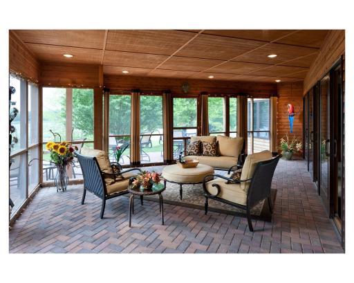 Enjoy the beauty overlooking the lake from the screened-in porch at Mary Hill Lodge
