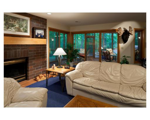 Lower level at the St. Anne House, complete with a cozy fireplace and screened-in porch