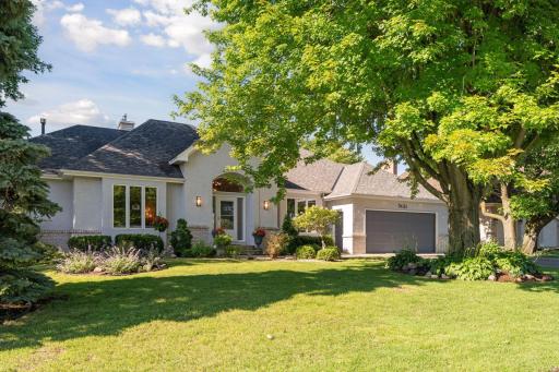 Stunning West Bloomington Walk Out Rambler overlooking beautiful wooded lot with pond and wetland beyond providing complete privacy from the rear of property.