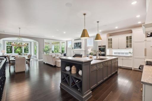 The main floor showcases a gourmet kitchen with spacious pantry, great room, sunroom, covered porch, home office, laundry room, and primary bedroom suite with spa-like bathroom.
