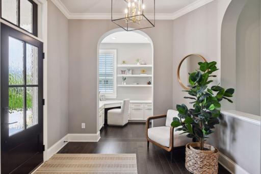 Design elements include arched doorways, white oak hardwood floors, floor-to-ceiling windows, and custom built-in cabinets.