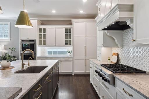 Gourmet kitchen including custom cabinetry, upgraded appliances, and a butler's pantry.