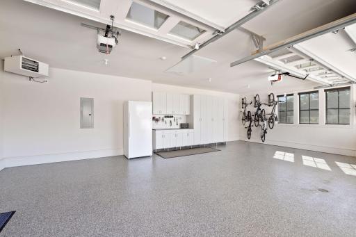 Completing this exquisite home is a three-car heated garage with epoxy floors and storage cabinets..