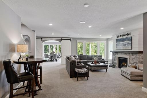 The lower level highlights a family room with wet bar, exercise room, three bedrooms, two bathrooms, and a flex room perfect for a golf simulator or home theatre.