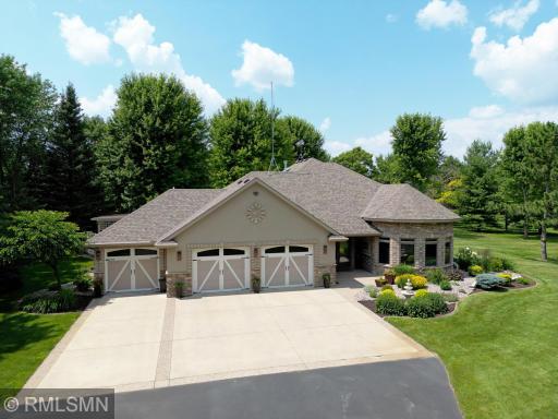 With its majestic, towering trees, this custom home looks and feels like your own private forest sanctuary with immaculate landscaping.
