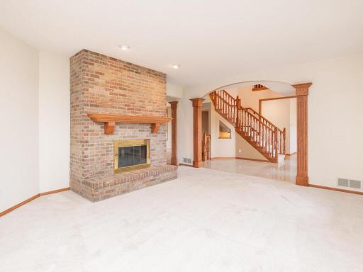 Formal Living Room has double-sided wood-burning fireplace shared with the Great Room.
