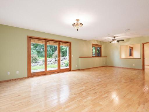 Generous Family Room has patio door leading to concrete Patio in Backyard.