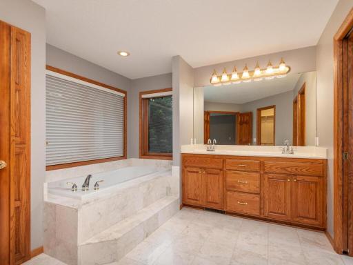 Primary Ensuite Bath features dual sink vanity, large soaking tub, and separate shower.