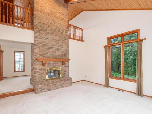 Impressive 2-Story Great Room features floor-to-ceiling wood-burning fireplace shared with the Formal Living Room.