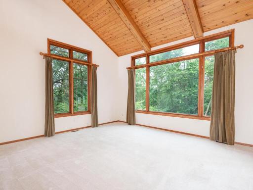 Sunken Great Room has vaulted wood/beamed ceiling and west-facing tree-top view!