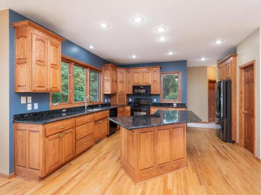 Well-appointed Kitchen features granite countertops, abundance of cabinetry, and large center island with breakfast seating.