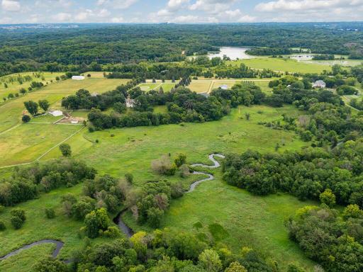 In the foreground, you can see the Credit River meandering along the back of the 10-acre property. In the background, you can see Murphy Lake and the wooded acreage of Murphy-Hanrehan Park Reserve with miles of trails for great horse-back riding!