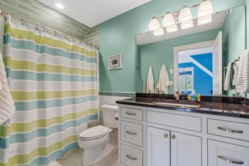 Upper level full bath with tile floors and granite countertop