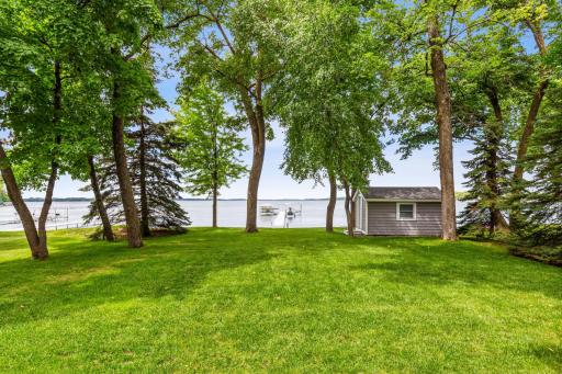 View of the yard between the home and lake