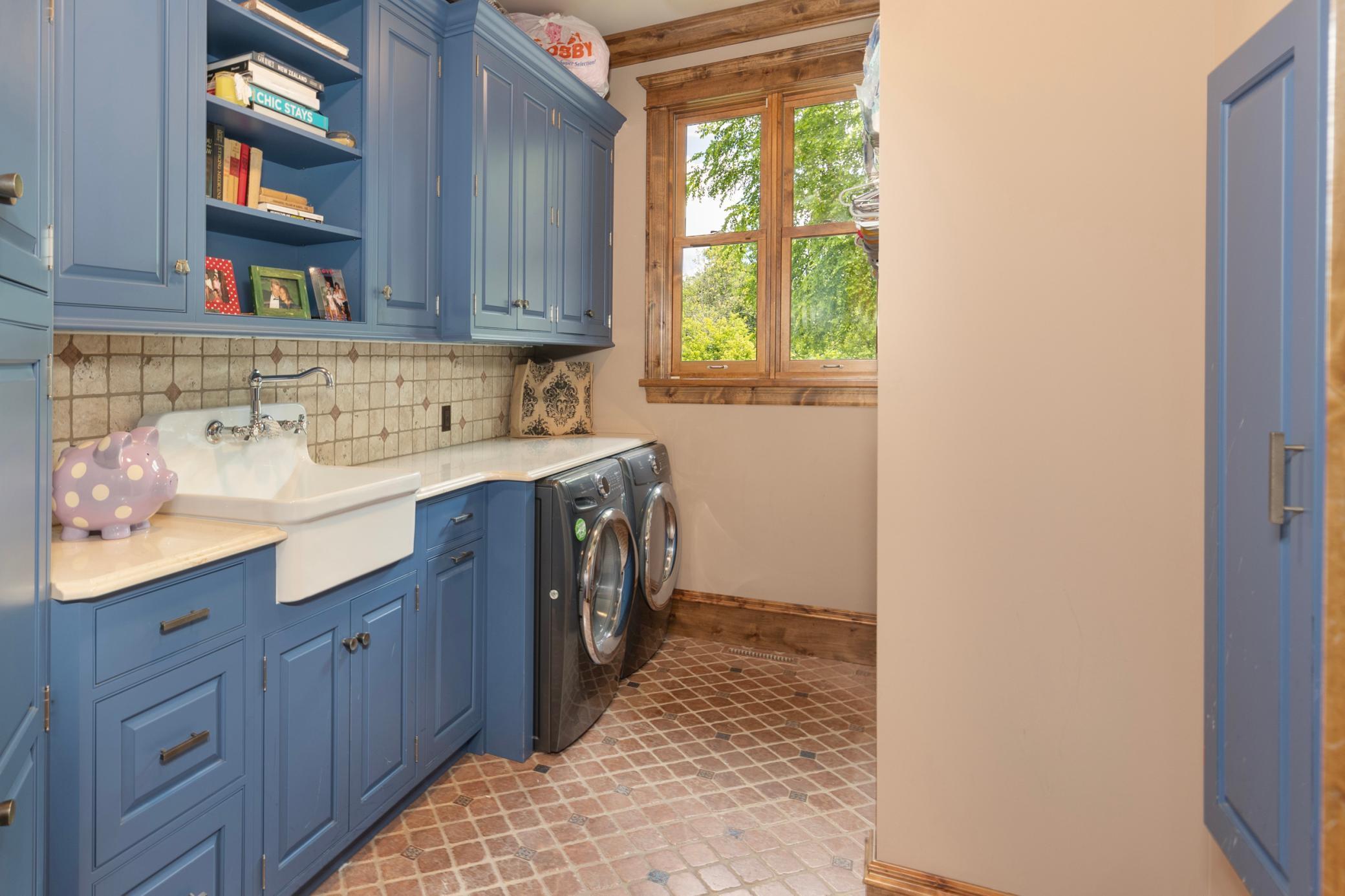 Main Floor Laundry Room - Adjacent to large Back Hall with Cubbies and access to heated Garages