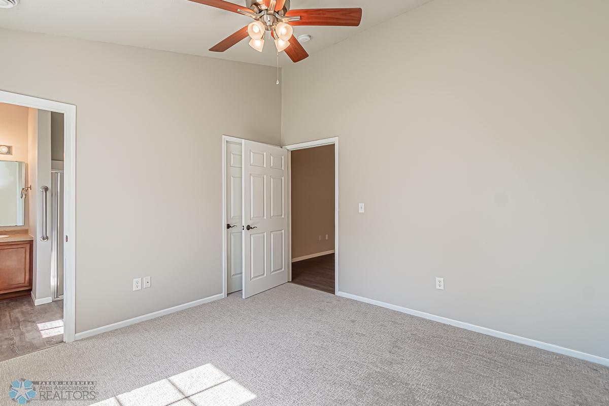 Primary bedroom with doors to closet and Living room