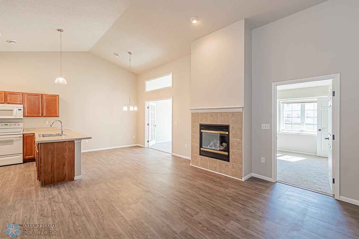 Living room, dining room and kitchen with vaulted ceilings