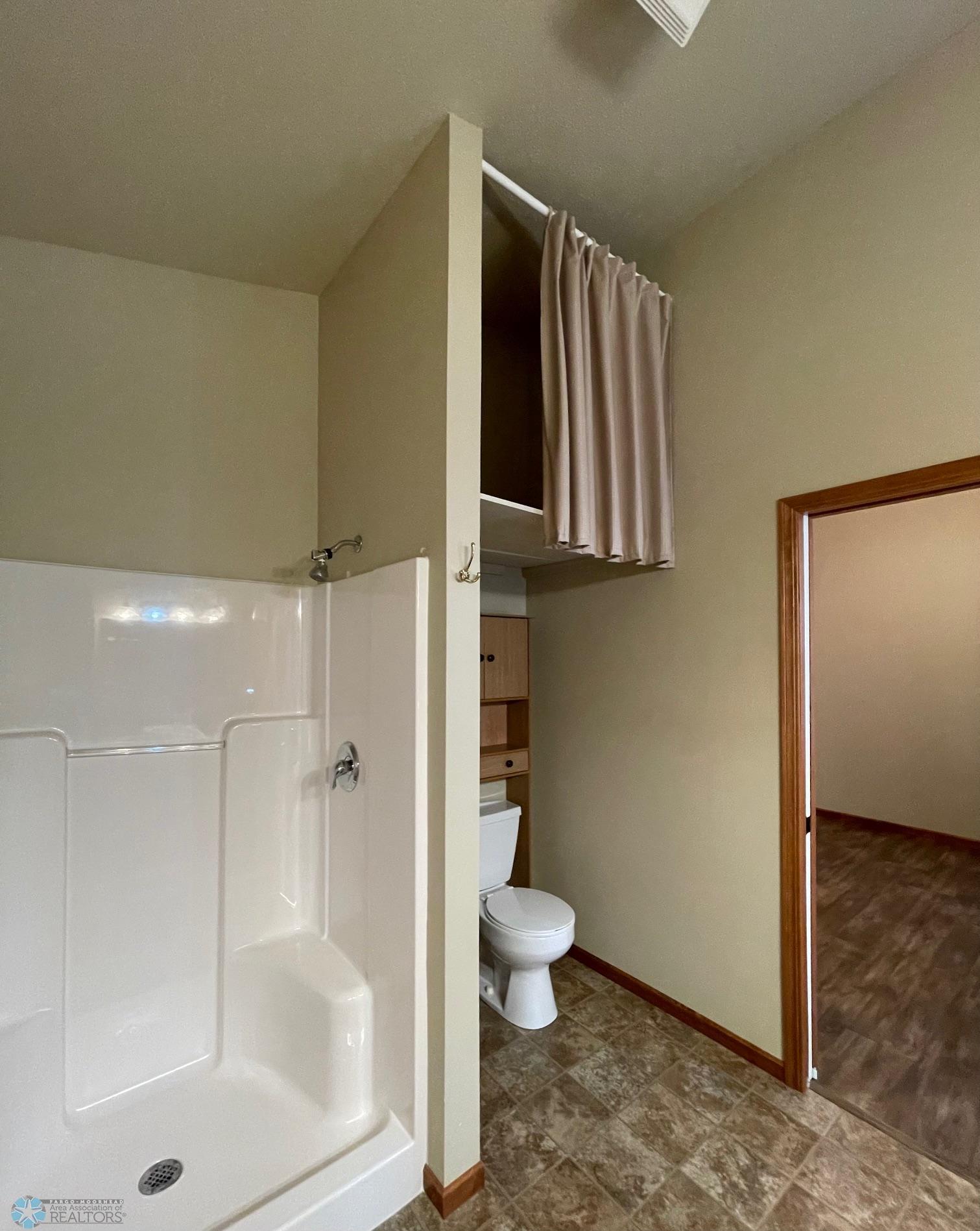 Master Bathroom (storage above stool)