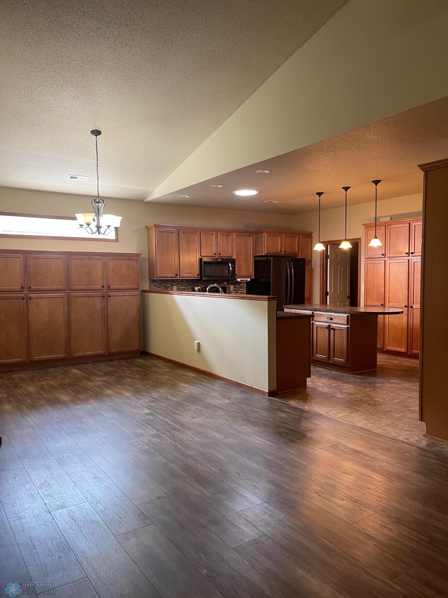 Living Room view towards Kitchen and Dining