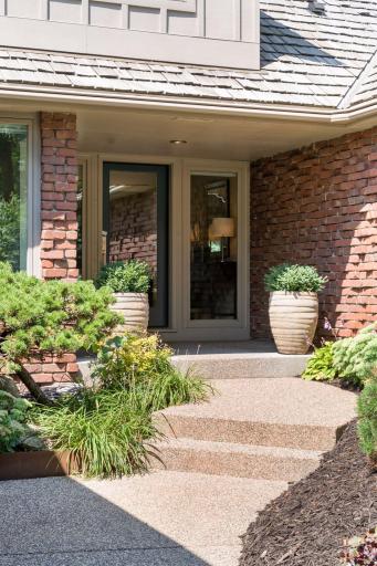 Welcoming front porch includes a new front door and sidelight windows