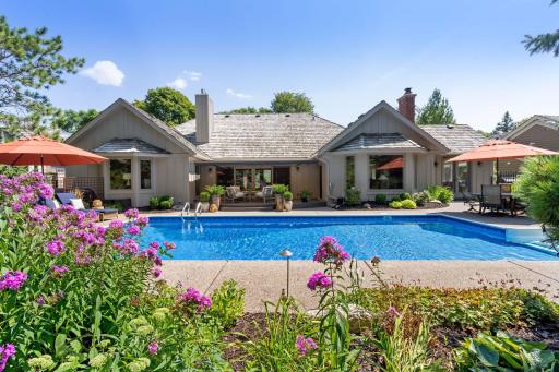 Lush landscaping and sparkling water give a resort feel to your home oasis