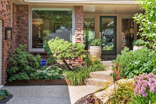 Floor to ceiling windows provide views of the entry garden.