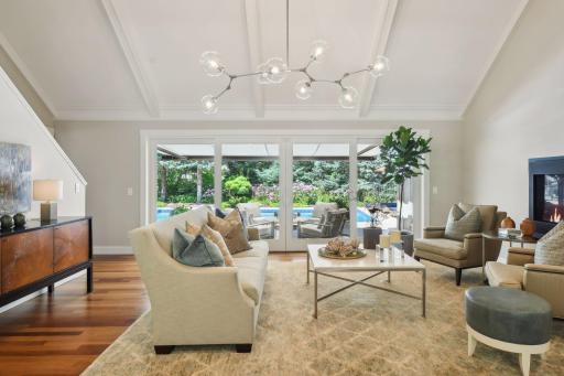 Step into the home and be instantly captivated by a wall of windows in the living room, offering a breathtaking view that leads directly to the swimming pool