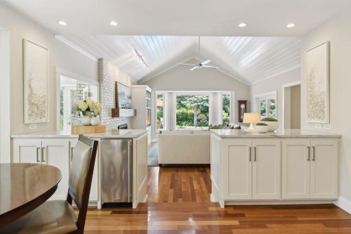 Built-in buffets add extra storage, a convenient beverage fridge and beautifully separate the kitchen and family room while keep an open airy feel