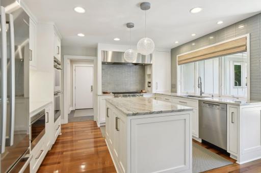 ompletely remodeled kitchen showcasing top-of-the-line stainless steel appliances, including Wolf ovens, range, and microwave, a Miele dishwasher, Bosch refrigerator, and a Marvel beverage refrigeratorâdesigned for both style and performance