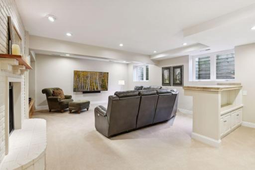 The lower level family room has a perfect wall for your big screen and boasts a stylish wet bar, making this space ideal for gatherings movie nights or watching the big game in style