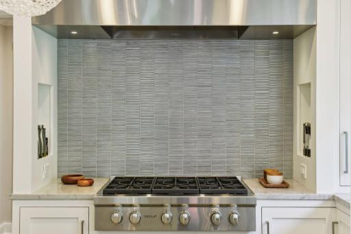 6 burner Wolf cook-top and custom stainless hood will delight even the most discerning chef