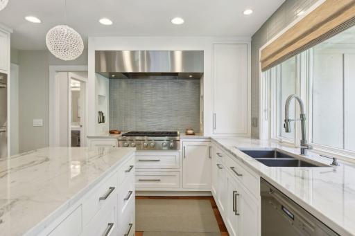 Designed to marry beauty and function the kitchen boasts Quartzite countertops, a new backsplash, custom stainless steel hood and high end lighting
Custom inset cabinets with soft close hinges