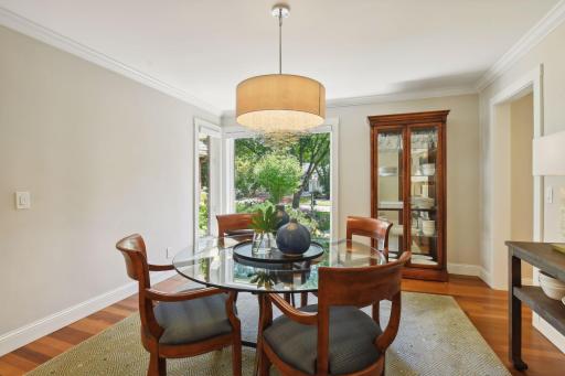 Formal dining room with floor to ceiling windows overlooking the front garden
