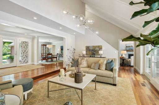With an open floor plan, soaring vaulted ceilings and oversized windows, this space is bathed in natural light, creating an airy and inviting atmosphere