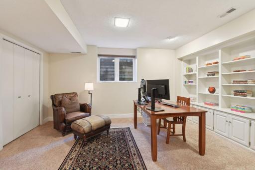 The lower level bedroom offers a built-in storage and display wall, with a convenient 3/4 bath just across the hall