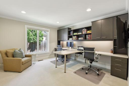 3rd main level bedroom features custom built office space