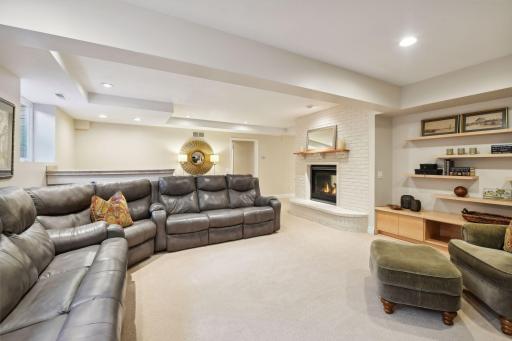 Egress windows fill the family room with natural light and the gas fireplace add a cozy atmosphere