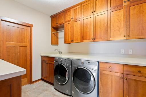 Laundry with custom cabinets designed to hold 6 laundry baskets