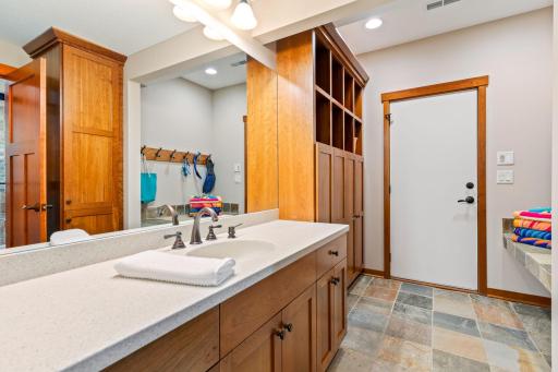 Lower level pool bath with heated floors, lockers and exit directly to pool area